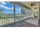 Open screened porch with brick flooring, ceiling fans, and views of the lush backyard and waterway at 8704 Middleton Point Ln, Edisto Island, SC 29438