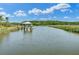 Scenic waterfront view showcasing a calm waterway with a charming gazebo and surrounding nature at 8704 Middleton Point Ln, Edisto Island, SC 29438