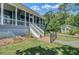 Exterior view of the fenced yard leading to the home, showcasing the landscaped lawn and surrounding greenery at 8704 Middleton Point Ln, Edisto Island, SC 29438