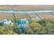 Stunning aerial view of waterfront property with multiple docks, lush greenery, and a large house at 944 Hammocks Way, Edisto Island, SC 29438