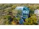 Expansive home with a green roof, surrounded by mature trees, a deck, and a winding staircase at 944 Hammocks Way, Edisto Island, SC 29438