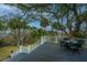 Outdoor back deck featuring seating and a view of lush greenery and palm trees at 944 Hammocks Way, Edisto Island, SC 29438