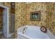 Bright bathroom featuring a soaking tub with a yellow floral wallpaper at 944 Hammocks Way, Edisto Island, SC 29438