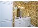 Charming bathroom with double vanity, floral wallpaper, and ample storage at 944 Hammocks Way, Edisto Island, SC 29438