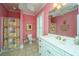 Bright bathroom with double vanity, colorful shower curtain, and ample lighting at 944 Hammocks Way, Edisto Island, SC 29438