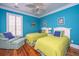 Bright bedroom with twin beds, matching chair, and ample natural light at 944 Hammocks Way, Edisto Island, SC 29438