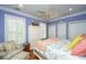 Cozy bedroom featuring hardwood floors, stylish furnishings, and a ceiling fan at 944 Hammocks Way, Edisto Island, SC 29438