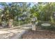 Gated entrance to a private residential community with mature trees and landscaping at 944 Hammocks Way, Edisto Island, SC 29438