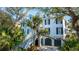 Charming exterior showcases the home's architectural details and picturesque surroundings at 944 Hammocks Way, Edisto Island, SC 29438