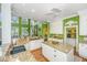 Well-lit kitchen with granite countertops, a large island, white cabinetry, and hardwood floors, creating an inviting atmosphere at 944 Hammocks Way, Edisto Island, SC 29438