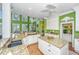 Bright and open kitchen with granite countertops, white cabinetry, and an island, offering a modern cooking space at 944 Hammocks Way, Edisto Island, SC 29438