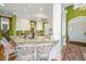 Beautiful kitchen with granite countertops, white cabinets, an island with seating, and hardwood floors, exuding charm at 944 Hammocks Way, Edisto Island, SC 29438