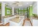 Open kitchen featuring granite countertops, a central island, and white cabinets, offering a bright and functional space at 944 Hammocks Way, Edisto Island, SC 29438
