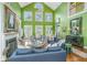 Bright living room featuring high ceilings, a fireplace, built-in shelving and an open floor plan leading to the dining area at 944 Hammocks Way, Edisto Island, SC 29438