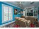Cozy living room features a large window with shutters, recliner seating, and built-in shelving at 944 Hammocks Way, Edisto Island, SC 29438