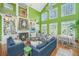 Bright living room featuring high ceilings, a fireplace, and an open floor plan leading to the dining area and natural light at 944 Hammocks Way, Edisto Island, SC 29438