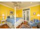 Spacious main bedroom with white canopy bed, ceiling fan, and French doors at 944 Hammocks Way, Edisto Island, SC 29438