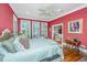 This main bedroom boasts large windows, wood floors, and a beautiful ceiling fan at 944 Hammocks Way, Edisto Island, SC 29438