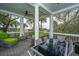 Enjoy outdoor dining on this screened-in porch with comfortable seating and picturesque views at 944 Hammocks Way, Edisto Island, SC 29438