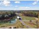 An aerial view features a community bridge surrounded by ponds and lush forest at 1006 Tulip Shell St, Summerville, SC 29485