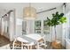 Bright dining area features stylish chandelier and ample natural light from the adjacent windows at 1008 Tulip Shell St, Summerville, SC 29485