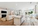 Bright open-concept living space with modern island kitchen, dining area, and cozy living room with fireplace at 1008 Tulip Shell St, Summerville, SC 29485
