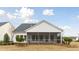 The backyard features a screened in porch and a view of the home's well manicured landscaping at 1014 Tulip Shell St, Summerville, SC 29485