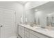 Bright bathroom featuring double sinks, a large mirror, and ample cabinet space at 1014 Tulip Shell St, Summerville, SC 29485