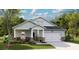 Charming single-story home with stone accents, covered porch, two-car garage, and manicured lawn at 1014 Tulip Shell St, Summerville, SC 29485