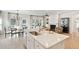 Elegant kitchen island with modern sink, stainless steel faucet, and view to dining and living areas at 1014 Tulip Shell St, Summerville, SC 29485
