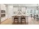 Modern kitchen featuring a center island with bar seating, stainless steel appliances, and sleek white cabinets at 1014 Tulip Shell St, Summerville, SC 29485