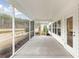Enjoy the outdoors from this screened porch with views of a lush backyard and serene pond at 1014 Tulip Shell St, Summerville, SC 29485