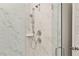 Modern bathroom shower features elegant marble tiling, rainfall shower head, and glass door at 1014 Tulip Shell St, Summerville, SC 29485