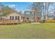 This large backyard features green grass, a wooden deck with handicap access, and a patio at 103 Laurens Ct, Summerville, SC 29485