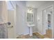 Bright bathroom featuring a pedestal sink and shower with tile floors and white walls at 103 Laurens Ct, Summerville, SC 29485