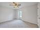 Light and airy bedroom showcasing carpeted floors, ceiling fan, and a window view at 103 Laurens Ct, Summerville, SC 29485