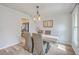 Traditional dining room with wood table, upholstered chairs, neutral decor, and view into modern kitchen at 103 Laurens Ct, Summerville, SC 29485