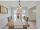 Traditional dining room with wood table, upholstered chairs, neutral decor, and lots of natural light at 103 Laurens Ct, Summerville, SC 29485
