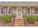 Close-up of the brick steps and front door featuring blue paint and an address plaque at 103 Laurens Ct, Summerville, SC 29485