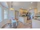 Charming eat-in kitchen featuring granite counters, wood cabinets, stainless steel appliances, and modern lighting at 103 Laurens Ct, Summerville, SC 29485