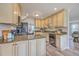 Renovated kitchen featuring stainless steel appliances, granite counters, breakfast bar, and wood cabinets at 103 Laurens Ct, Summerville, SC 29485
