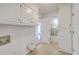 Bright and functional laundry room with tile floors, and lots of storage at 103 Laurens Ct, Summerville, SC 29485