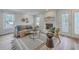 Well-lit living room with a cozy couch, chair, and view of the backyard at 103 Laurens Ct, Summerville, SC 29485