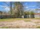 Spacious backyard featuring a shed, surrounded by a wooden fence and mature trees at 103 Sprucewood Dr, Summerville, SC 29485