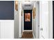 Hallway with dark colored walls and hardwood floors lead to other parts of the house at 103 Sprucewood Dr, Summerville, SC 29485