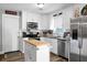 This is a bright kitchen with white cabinets, stainless appliances, and island at 103 Sprucewood Dr, Summerville, SC 29485