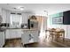 This is a bright kitchen with white cabinets and island next to a dining area at 103 Sprucewood Dr, Summerville, SC 29485