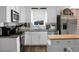 Modern kitchen features white cabinets, stainless steel appliances, and a central island at 103 Sprucewood Dr, Summerville, SC 29485