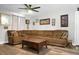Cozy living room with a large sectional sofa, ceiling fan, and decorative wall art at 103 Sprucewood Dr, Summerville, SC 29485