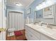 The light blue and white bathroom features double sinks and plenty of lighting at 104 Gervais St, Walterboro, SC 29488